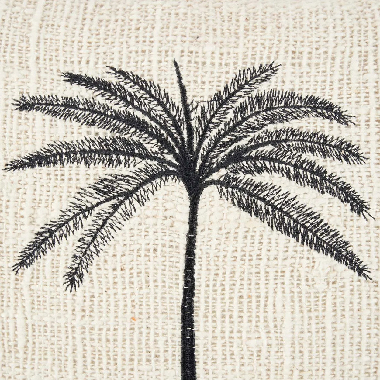 Black palm tree design on a textured beige background