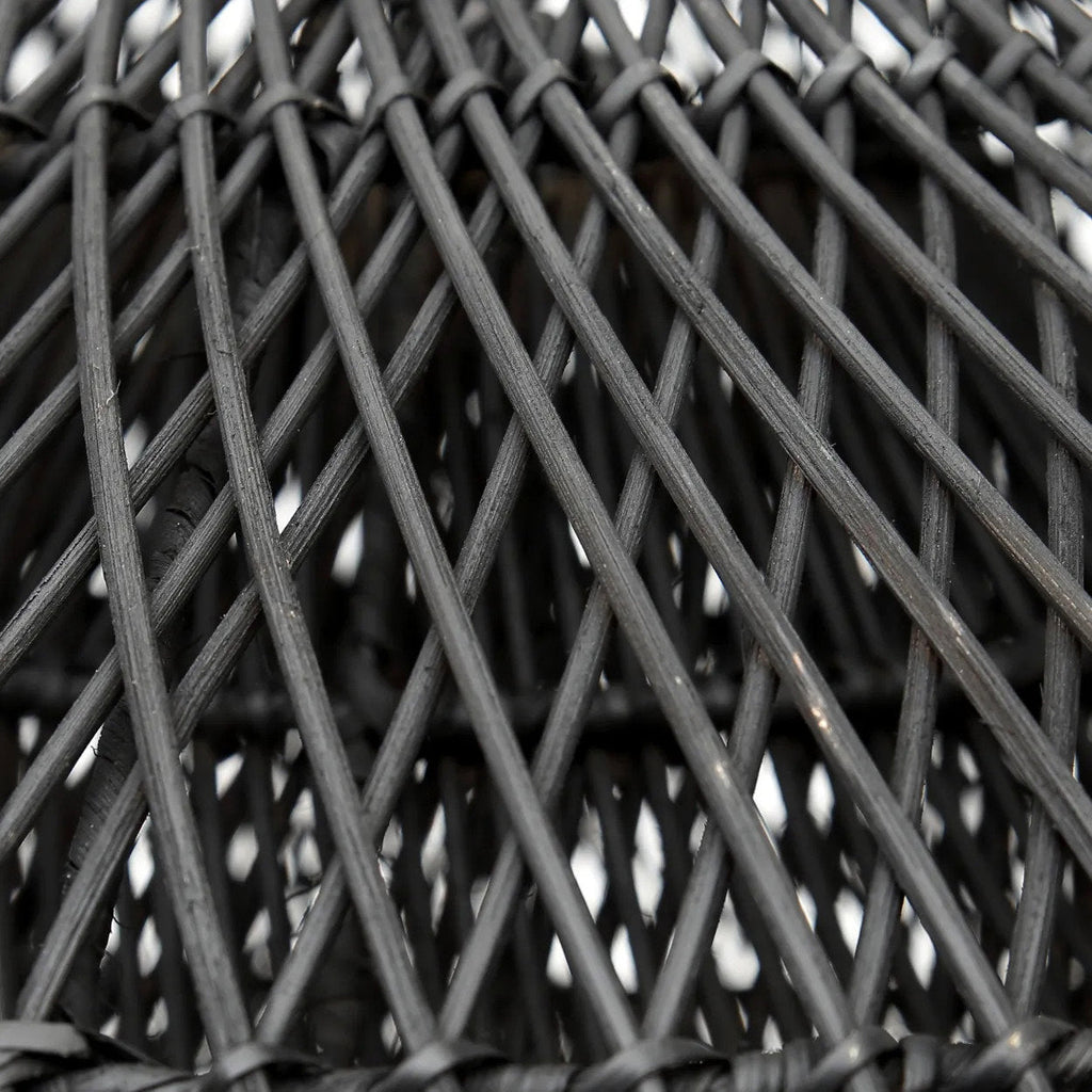 Close-up of a woven black lampshade with interlocking strands.