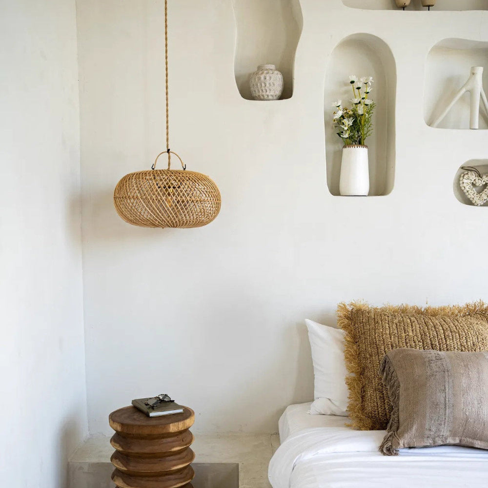 Boho bedroom with a bed, side table, and wall shelves.