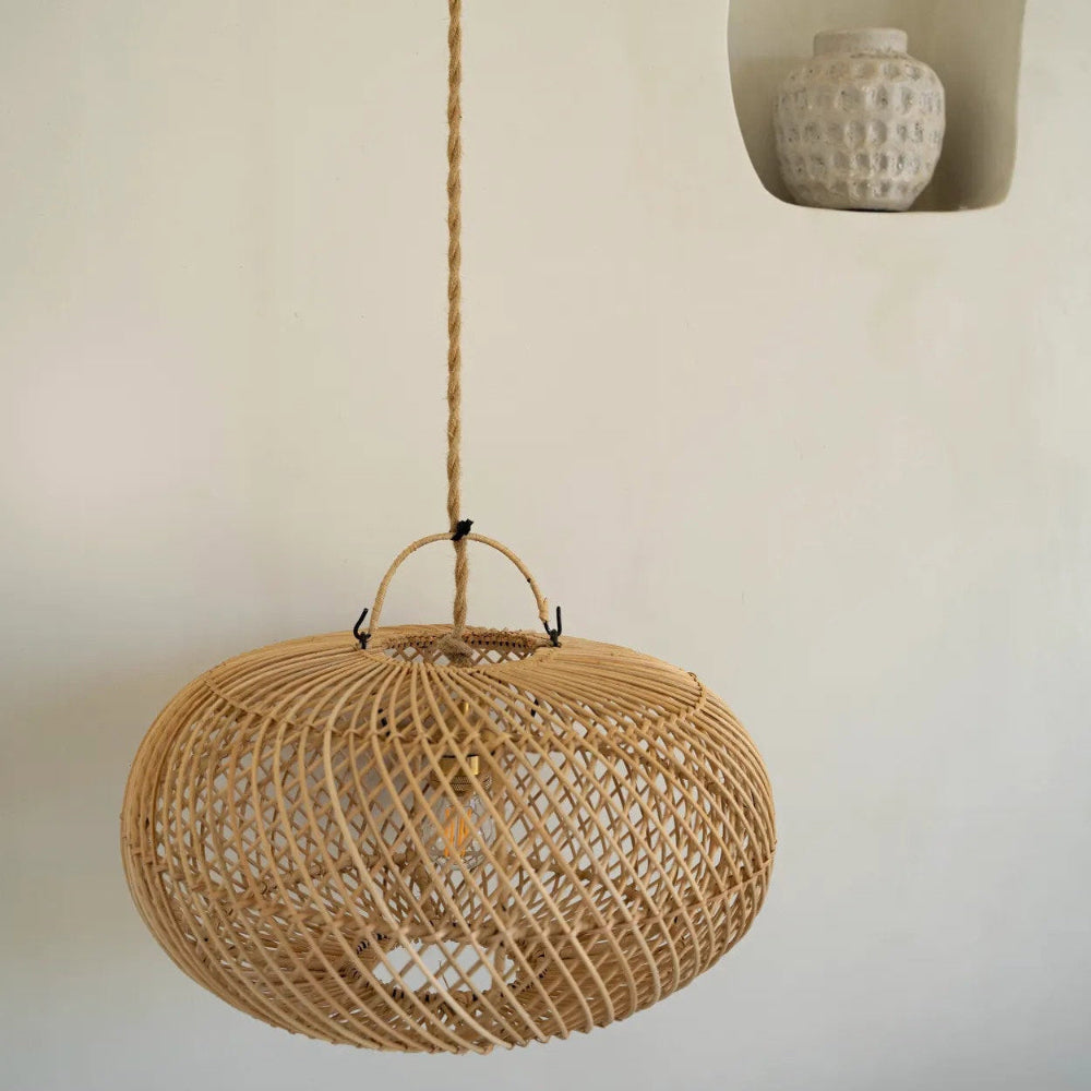 Woven pendant light hanging against a neutral wall