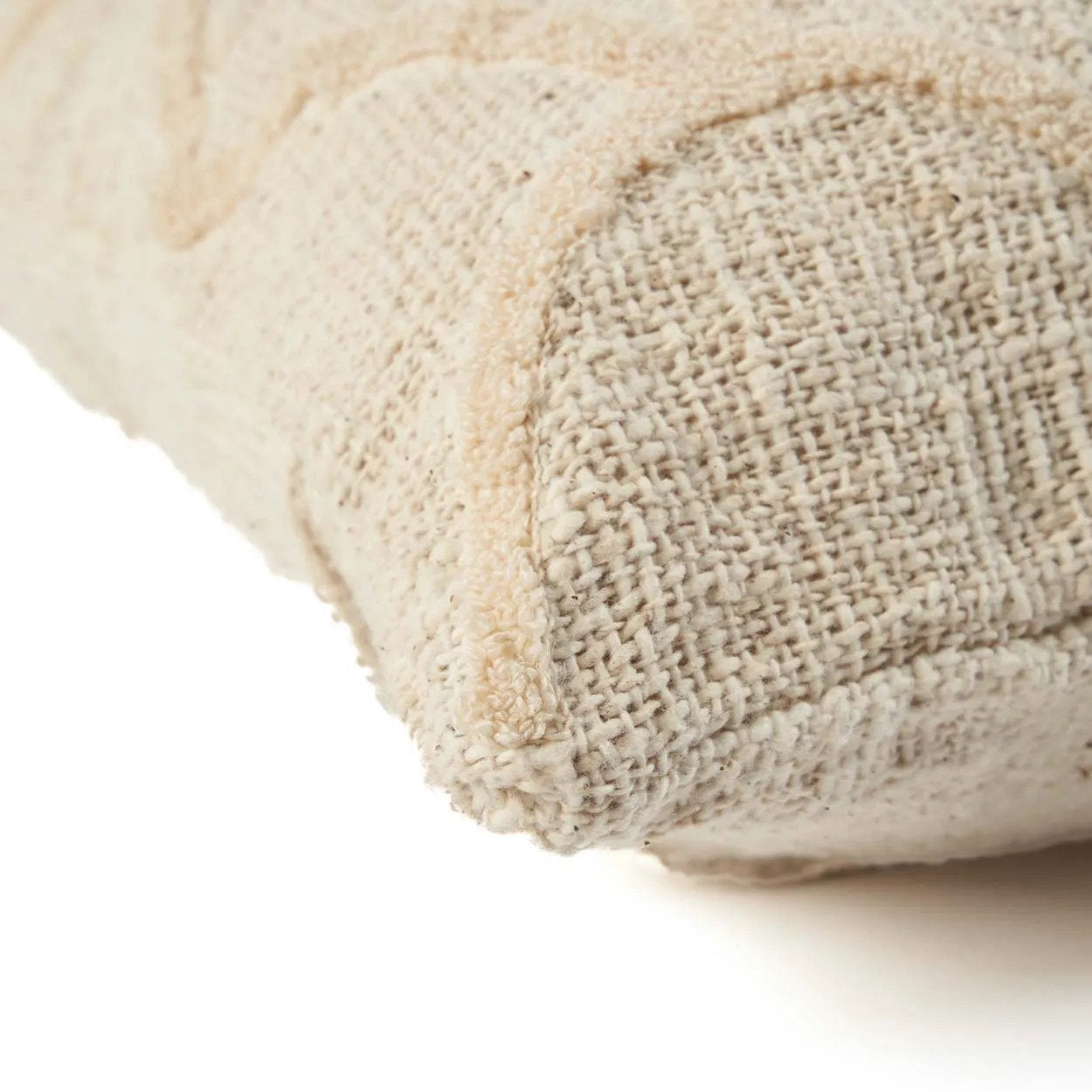 Close-up of a textured beige fabric cushion