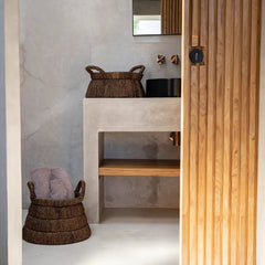 Bathroom interior with a wooden door and wicker baskets