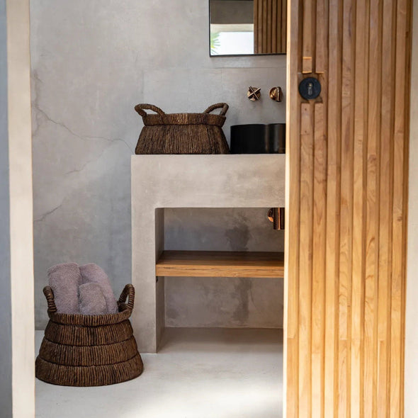 Bathroom interior with a wooden door and wicker baskets