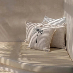 Decorative white cushions with palm tree design