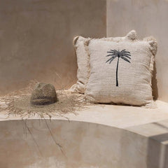 Textured cushion with palm tree design 