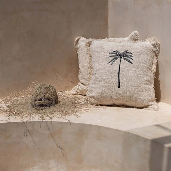 Textured cushion with palm tree design 