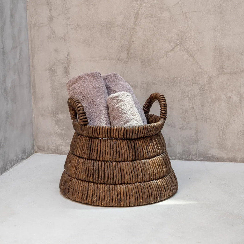 Woven basket with folded towels
