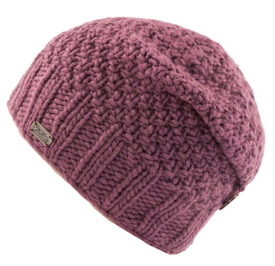 A dusty rose purple chunky knit beanie hat with a small metal brand tag reading 'KuSan' on the side