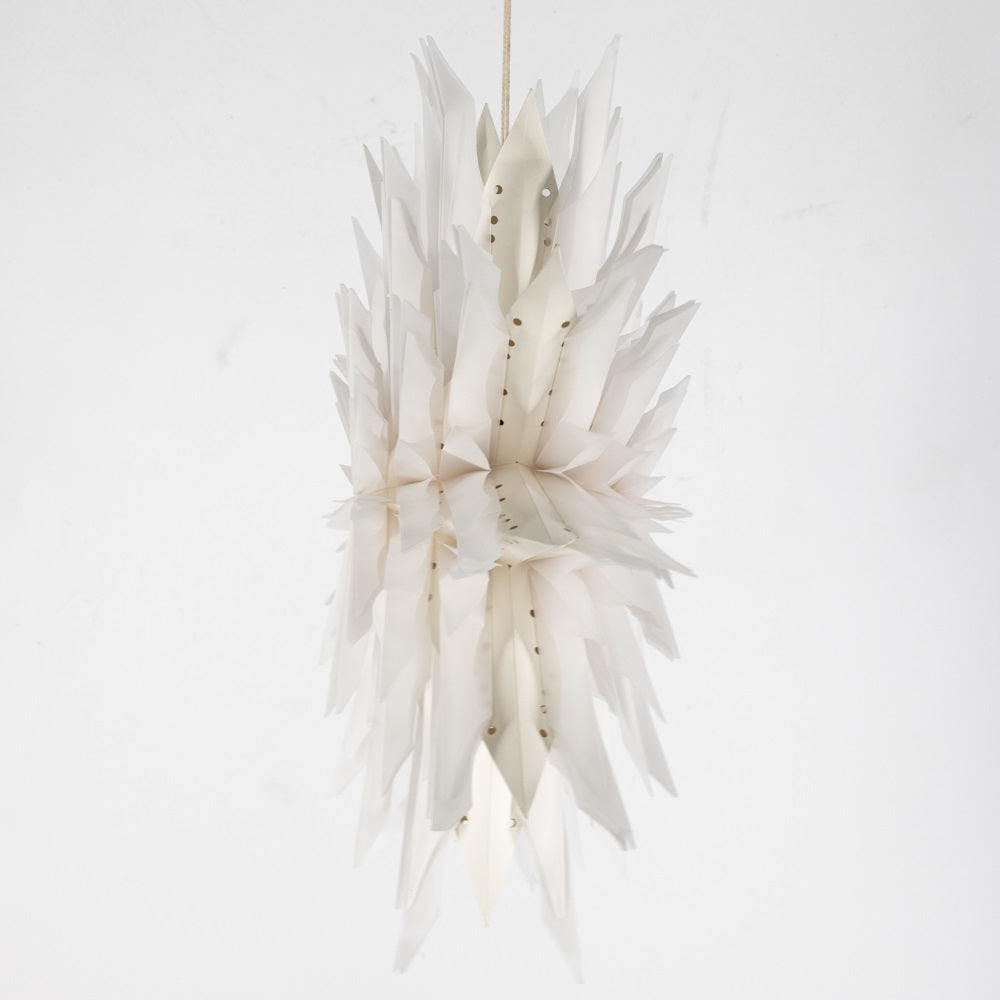 A modern, organic-shaped hanging pendant light made of layered, translucent white paper or fabric petals