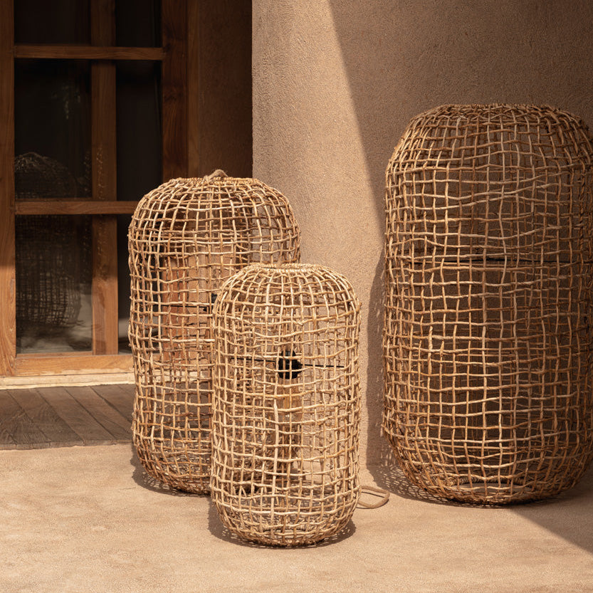 Close-up of a woven rattan lampshade on a white background