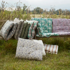 Bohemian-style garden lounge with layered printed cotton mattresses by Madam Stoltz