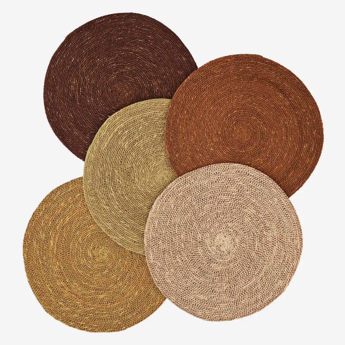Set of five round woven seagrass placemats in various earthy tones 