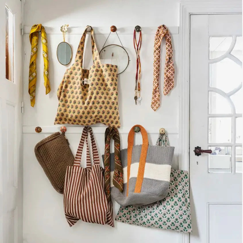A styled entryway covered in hanging accessories by Madam Stoltz