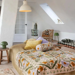 Bedroom with floral quilt and colorful pillows on a bed