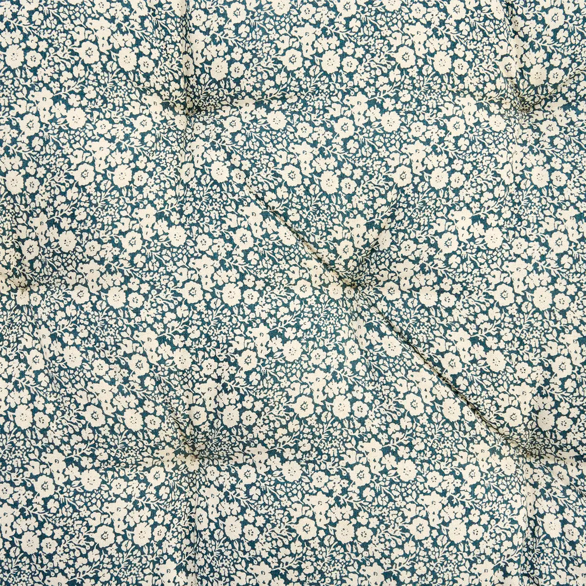 Floral patterned fabric with small white flowers on a dark blue background