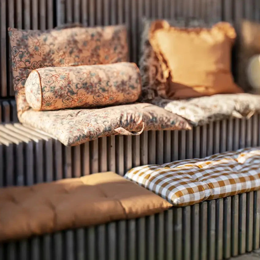 Decorative pillows and cushions on a wooden bench