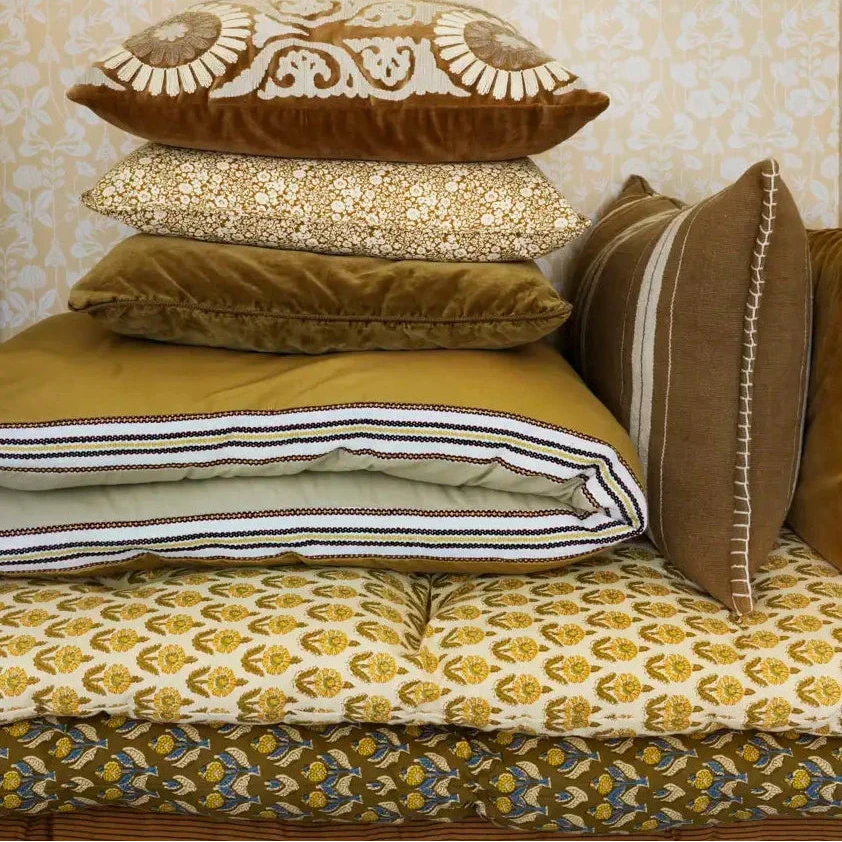 Decorative pillows on a patterned mattress cushion by Madam Stoltz