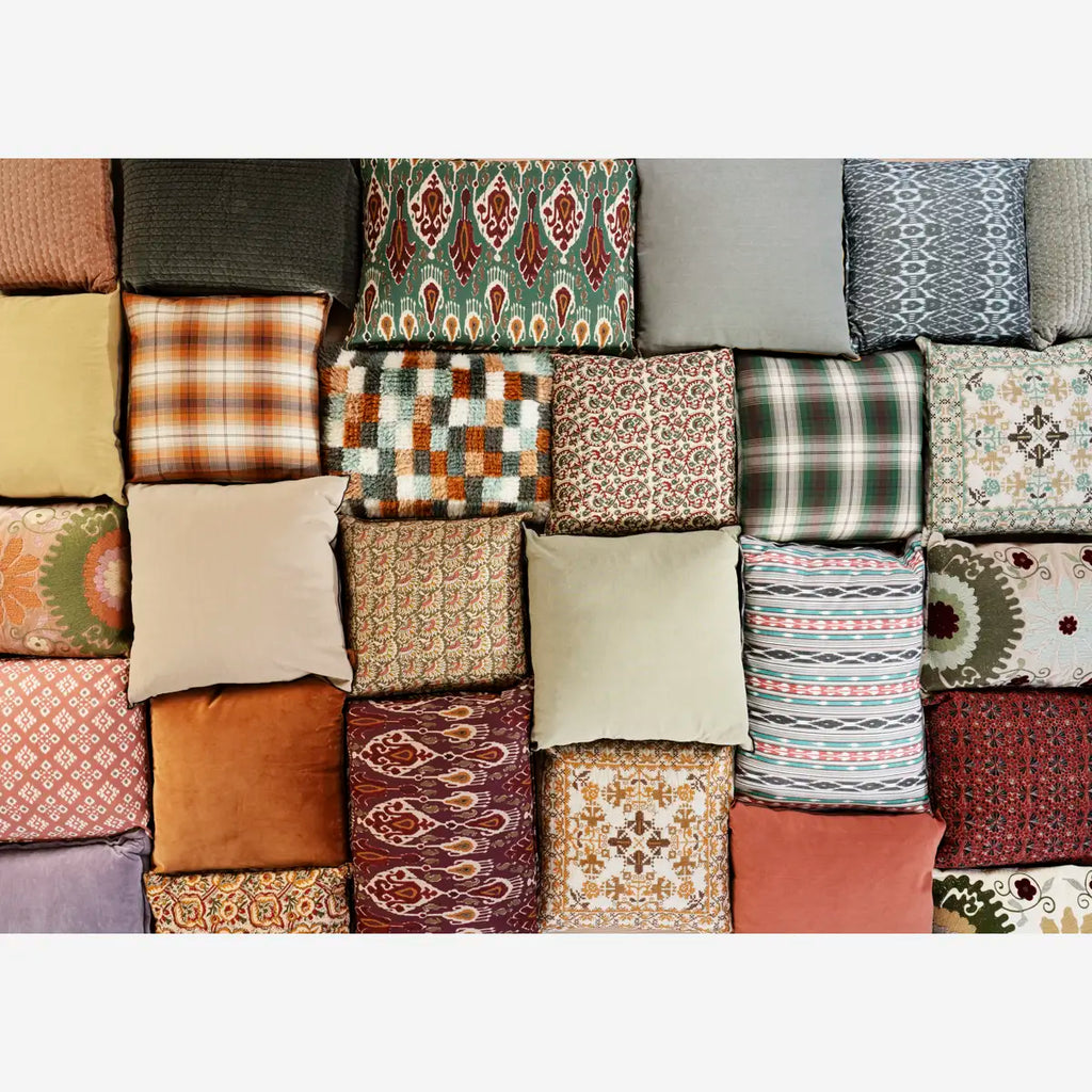 Collection of various patterned cushions arranged in a grid.