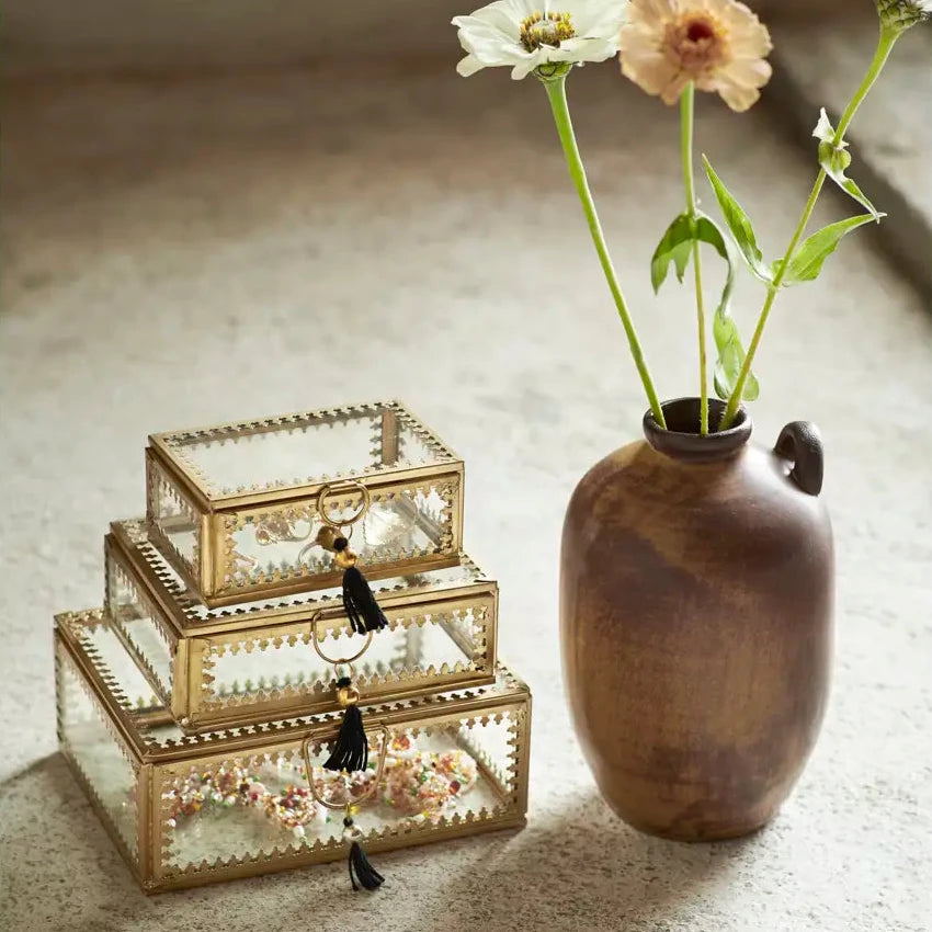Decorative glass jewellery boxes and a vase with flowers by Madam Stoltz