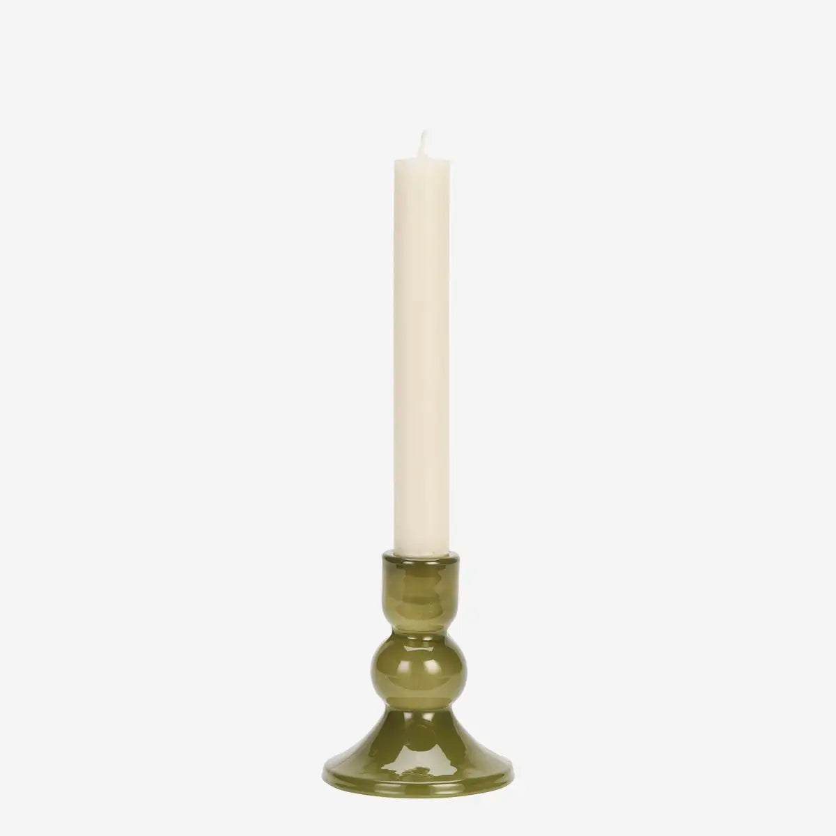 An olive green glass candlestick holder with a single white dinner candle