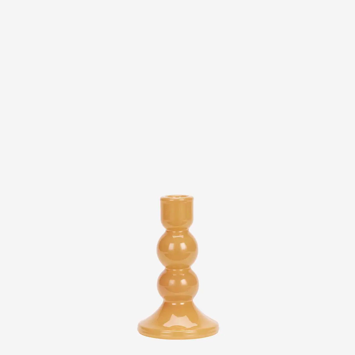 A small glossy amber-brown ceramic candlestick holder with a flared base and three stacked rounded segments, centered on a plain white background.