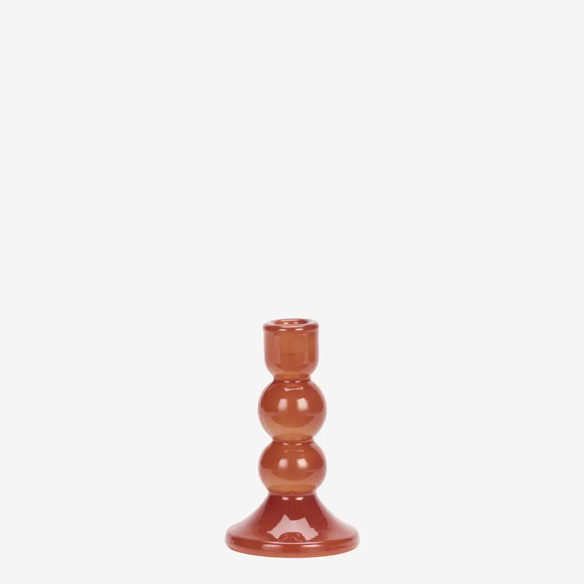 A small glossy terracotta-colored glass candlestick holder with a bulbous, stacked design, centered against a solid white background.