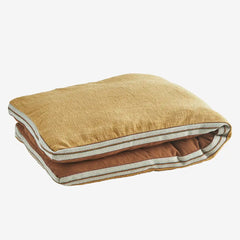 Madam Stoltz printed cotton mattress cushion on wooden bench in boho garden setting
