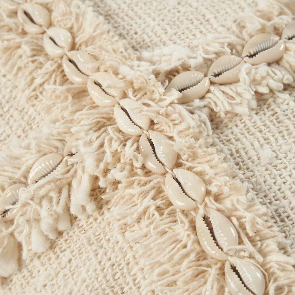 Close-up of a decorative boho shell cushion