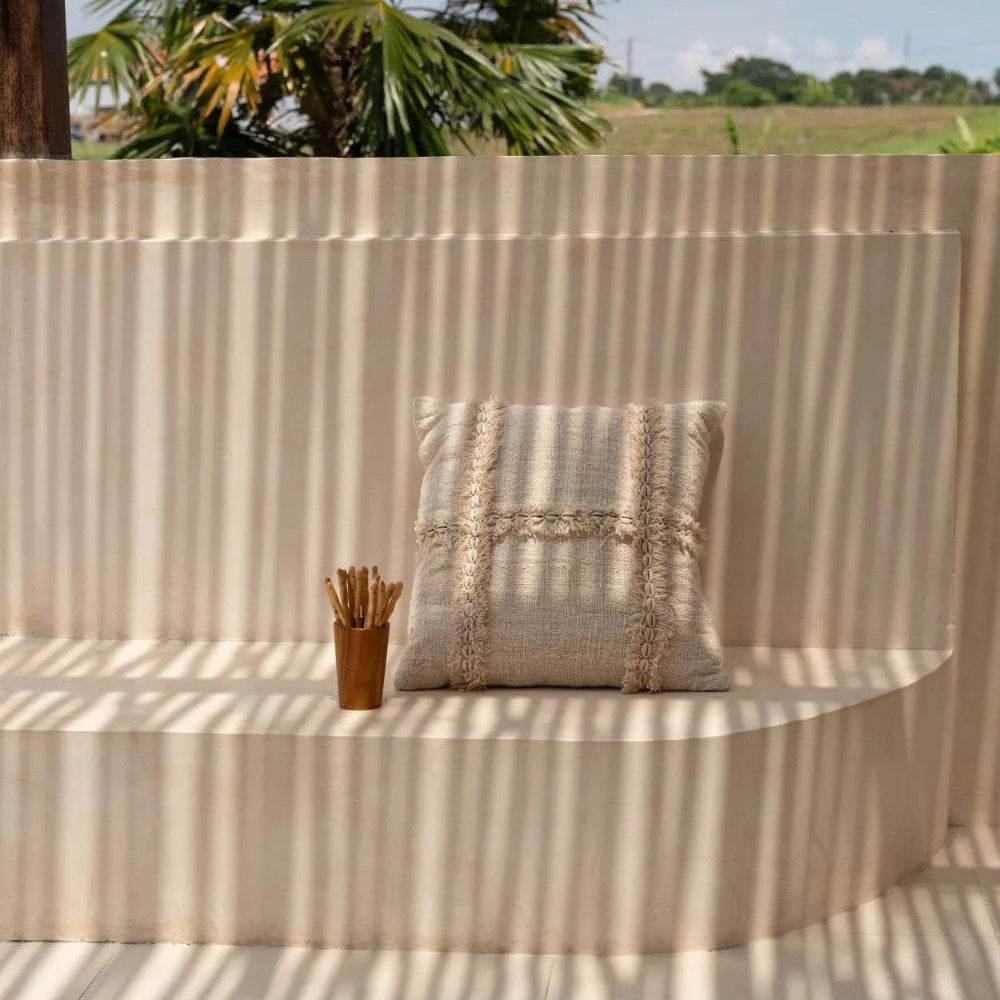 Beige cushion on a curved wall with palm trees