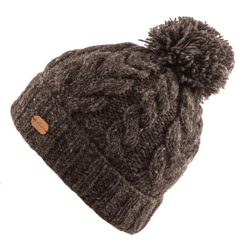 A dark brown cable-knit beanie hat with a matching fluffy pom-pom on top