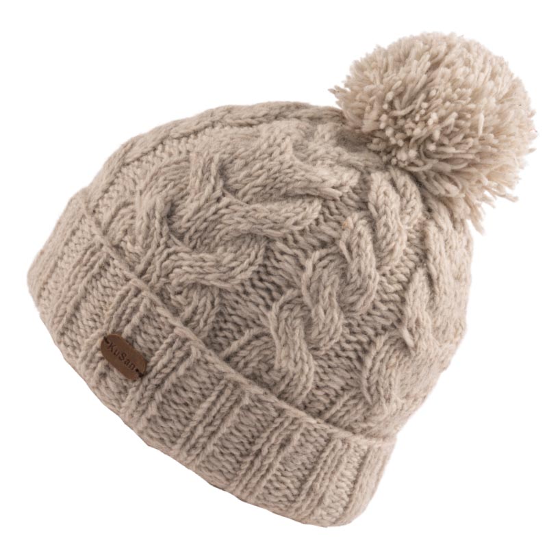 A beige cable-knit beanie with a matching pom-pom
