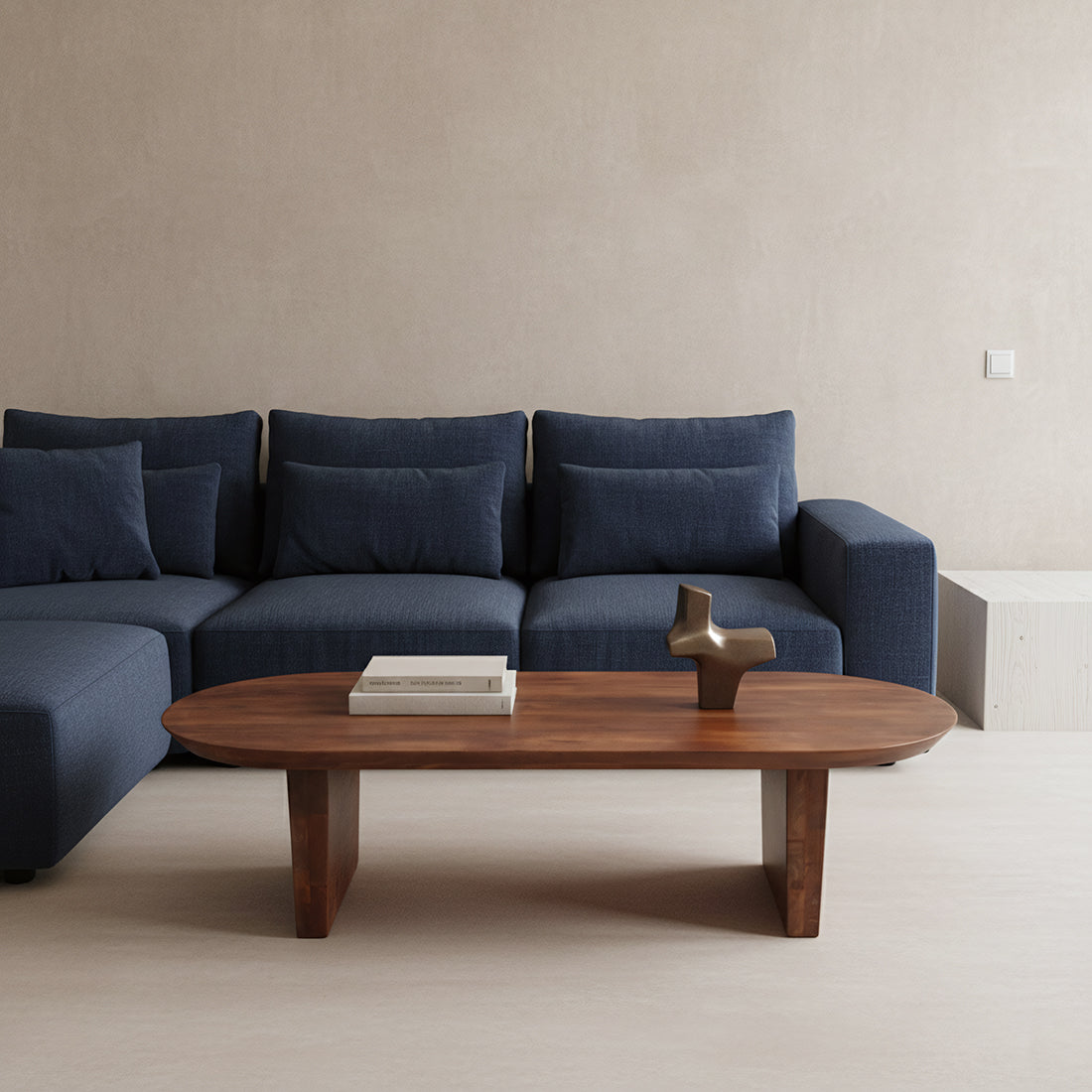 Blue sectional sofa with a wooden coffee table in a minimalistic living room.