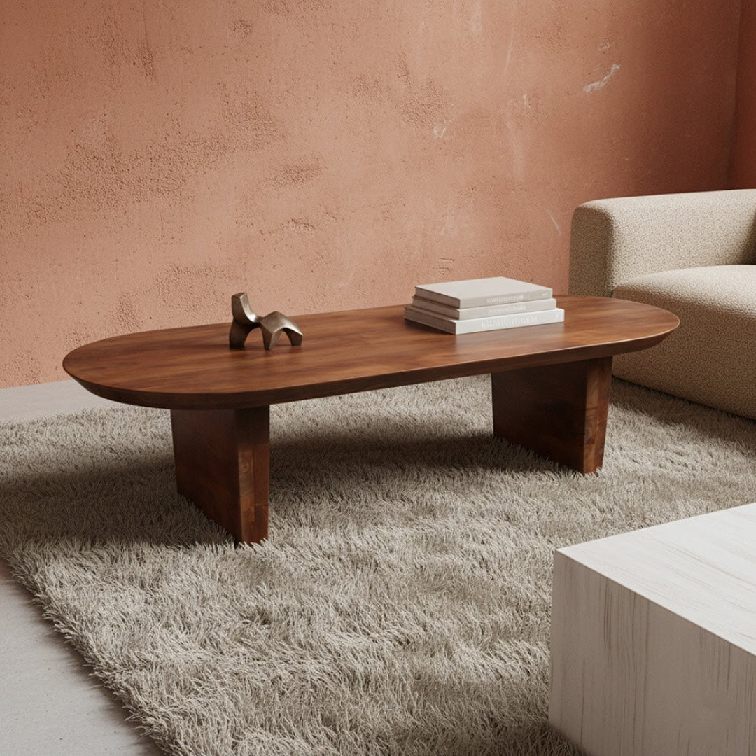 Wooden coffee table with decorative items in a living room setting.