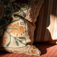 Decorative pillow with floral patterns on a textured surface