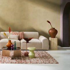 Modern living room with a beige sofa, decorative vases, and a coffee table.