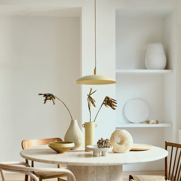 Modern interior with a round marble table, chairs, and decorative items.