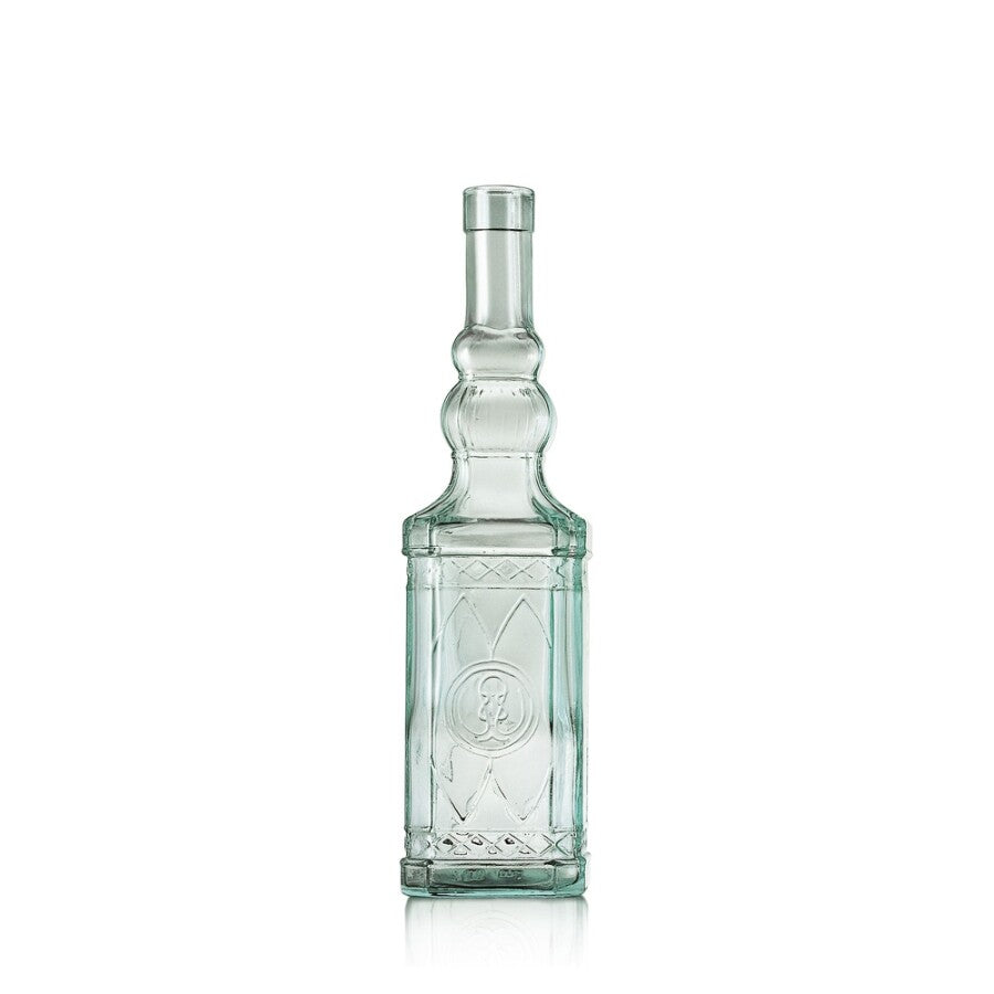 A clear glass bottle with a narrow neck and embossed geometric patterns on the front