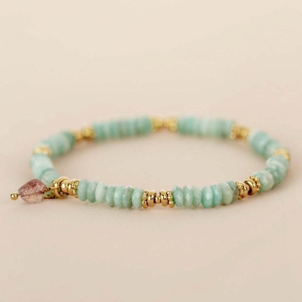 Beaded bracelet turquoise with gold accents and a pink heart