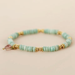 Beaded bracelet turquoise with gold accents and a pink heart