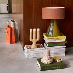 Decorative items including a lamp, books, and candle holder in interior.