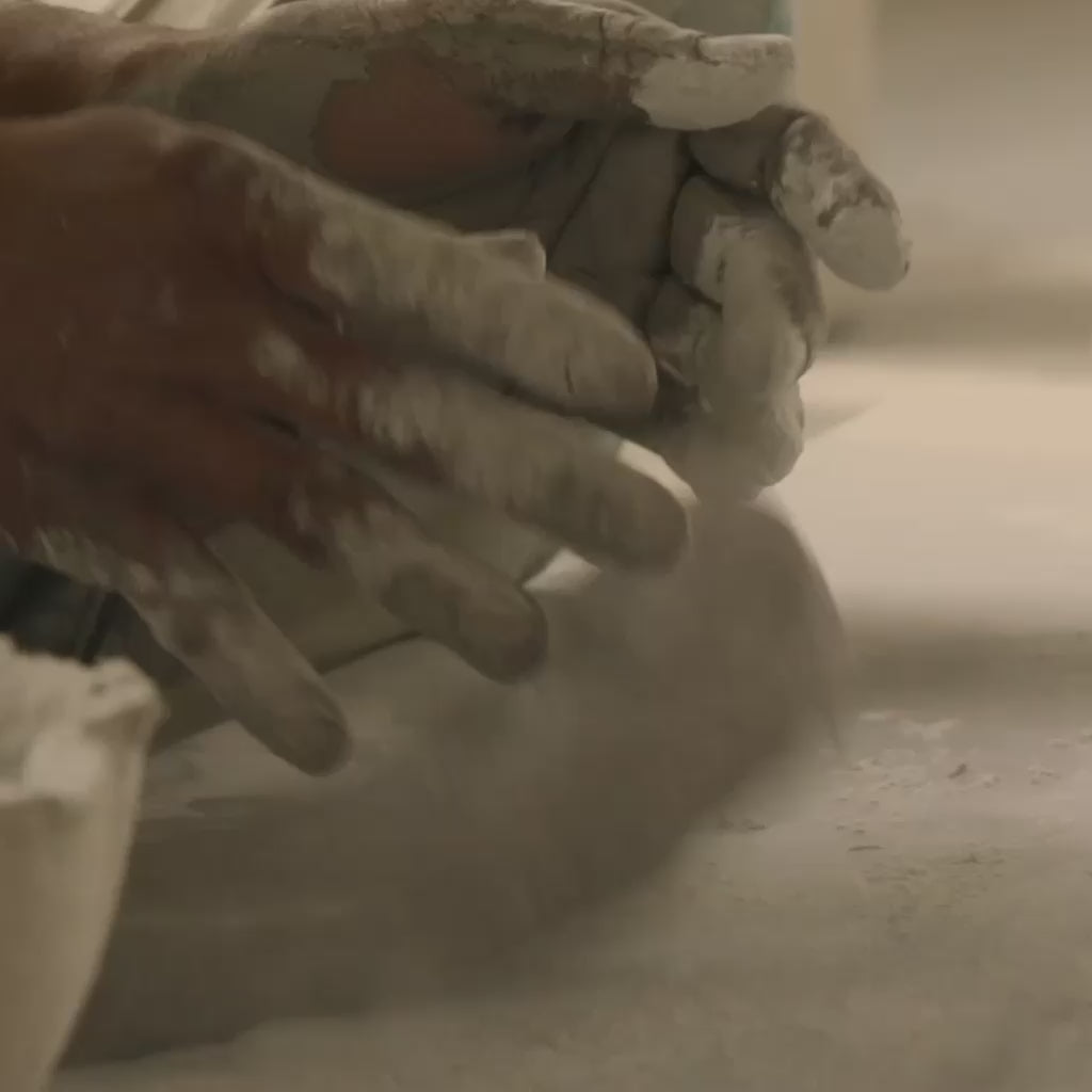 Close-up of hands working with clay on a pottery wheel
