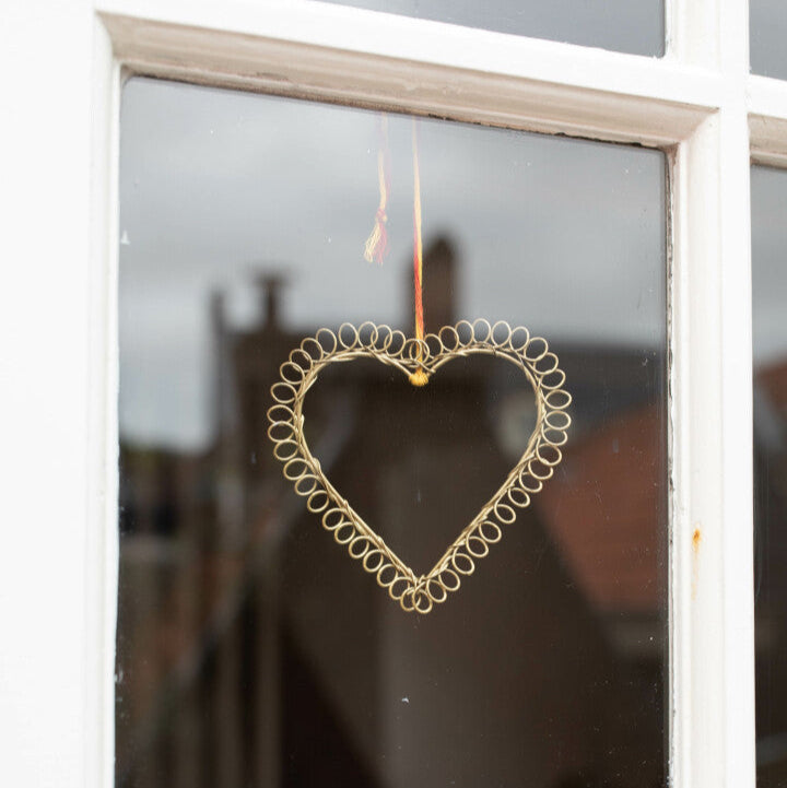 Heart-shaped decorative item hanging on a window