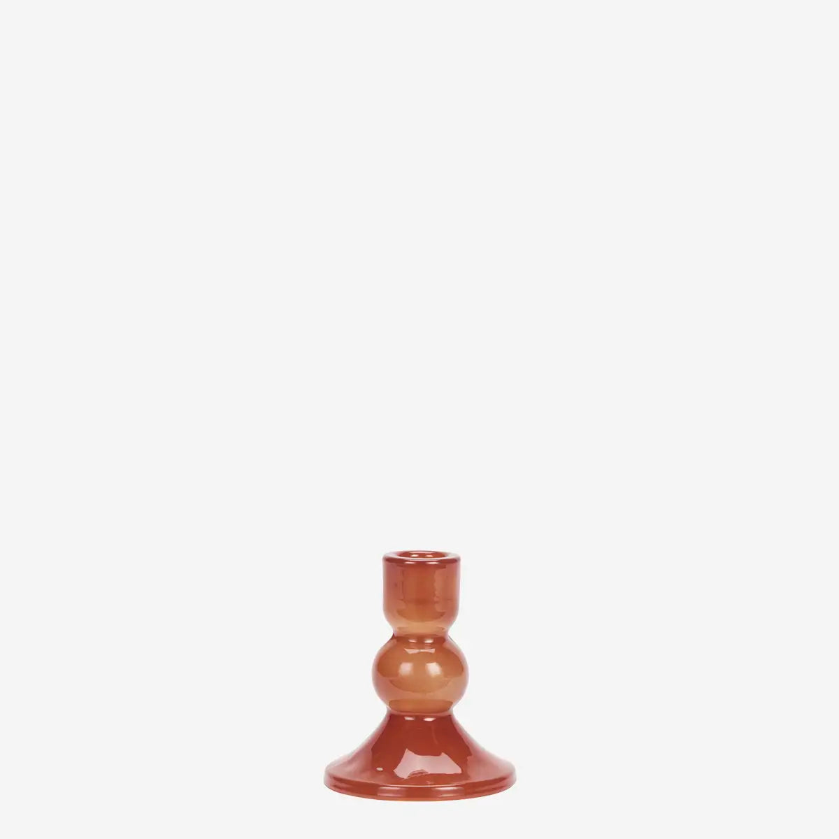 A small glossy glass candlestick holder with a warm terracotta and orange-brown gradient