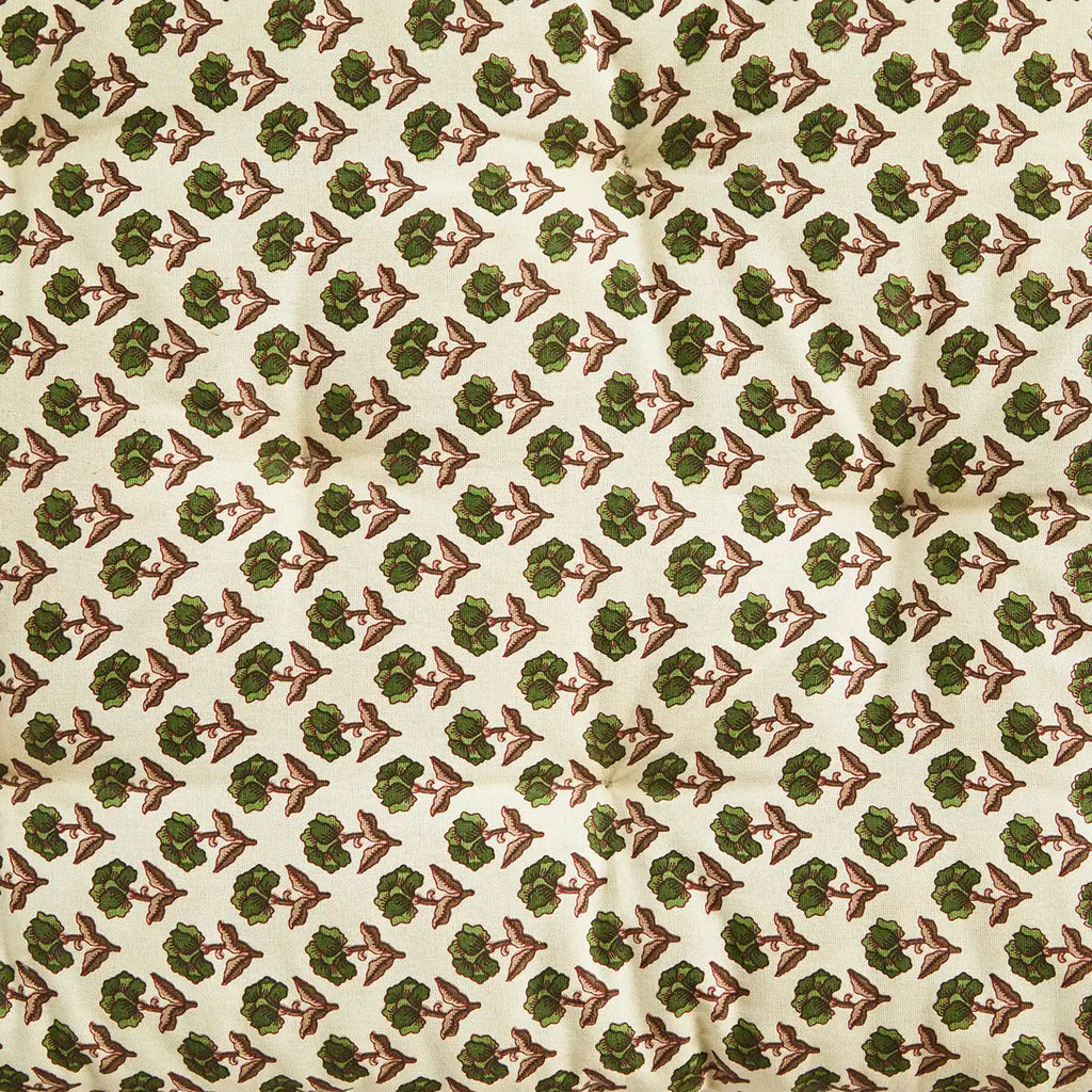 Patterned fabric with green and burgundy design on a beige background
