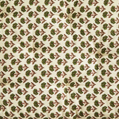 Patterned fabric with green and burgundy design on a beige background