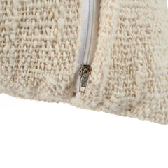Close-up of a textured beige cushion with a zipper