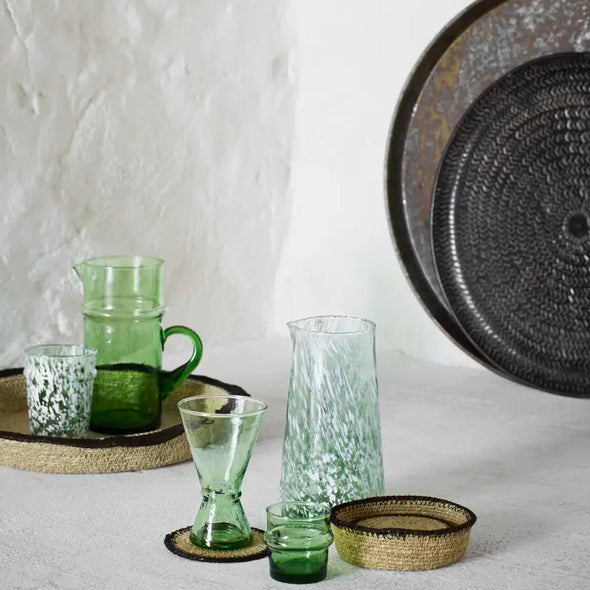 seagrass coasters with stitching in a setting Madam Stoltz