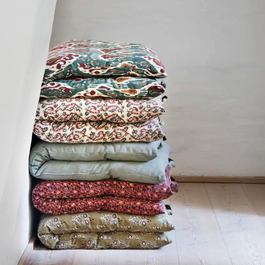 a stack of printed cotton mattresses by Madam Stoltz