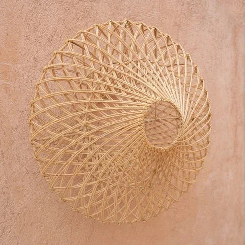 Decorative woven rattan lamp on a textured pink wall