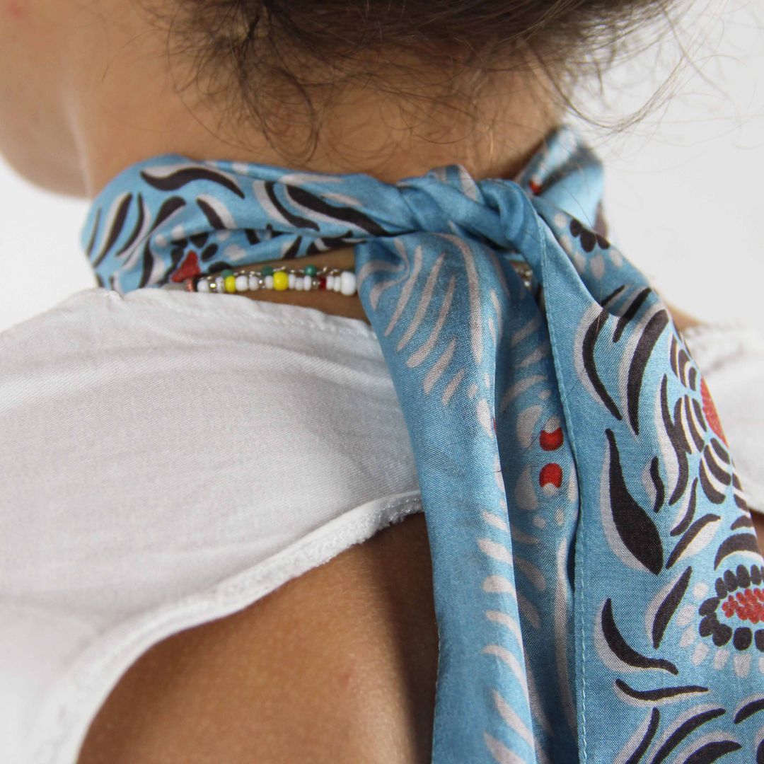 Les Belles Vagabondes Silk Twilly Camelia Blue Shown Wearing as a Scarf